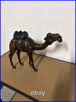 Vintage aged leather camel sculpture on hand-carved wood