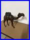 Vintage aged leather camel sculpture on hand-carved wood