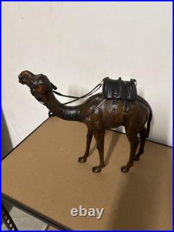 Vintage aged leather camel sculpture on hand-carved wood