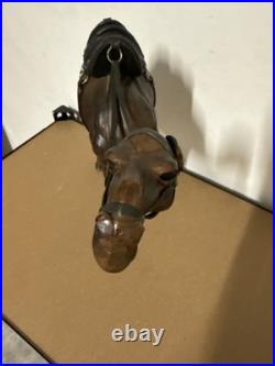 Vintage aged leather camel sculpture on hand-carved wood