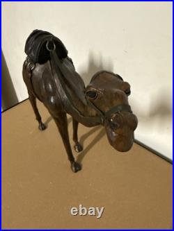 Vintage aged leather camel sculpture on hand-carved wood