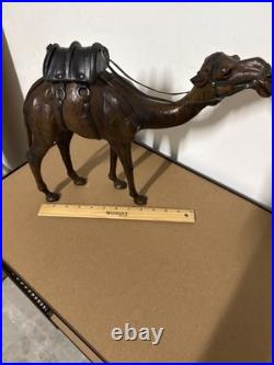 Vintage aged leather camel sculpture on hand-carved wood
