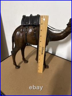 Vintage aged leather camel sculpture on hand-carved wood